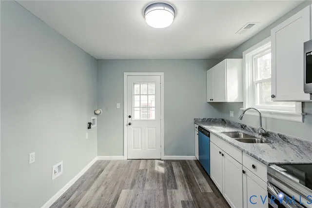 a kitchen with sink and cabinets