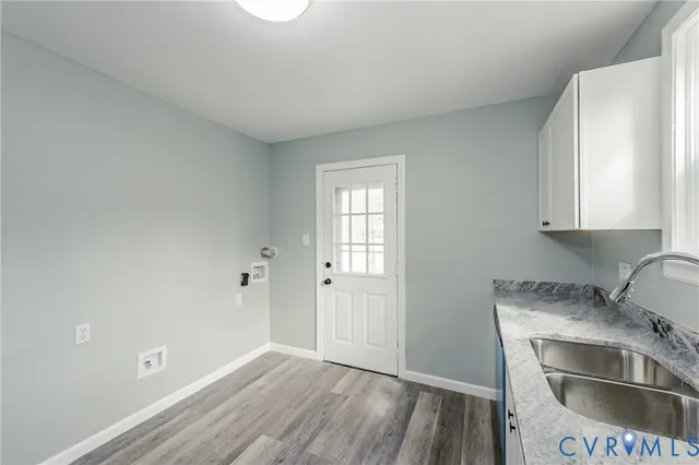 a kitchen with granite countertop a sink and a stove top oven