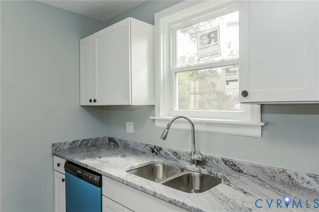 a kitchen with a sink cabinets and window
