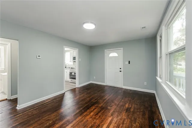 wooden floor in an empty room with a window