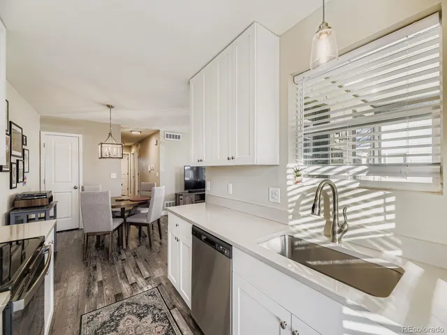 a kitchen that has a sink and a stove in it