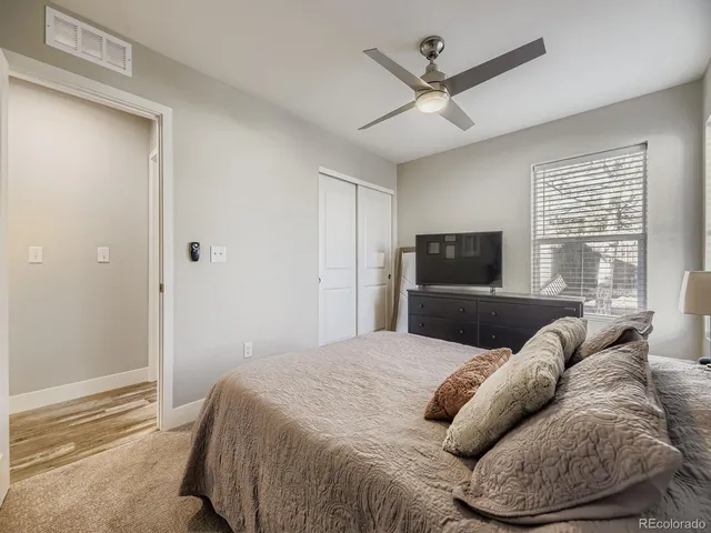 a bedroom with a large bed and a window