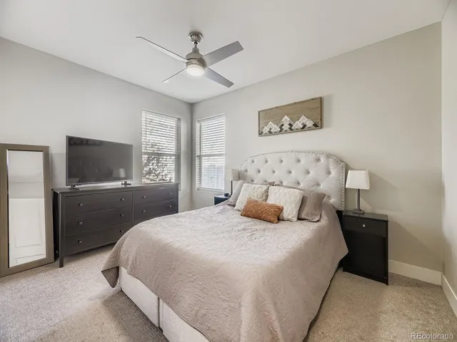 a bedroom with a large bed and a tv