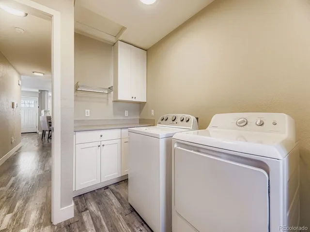 a view of washer and dryer with kitchen in the background