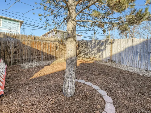 a view of a chairs and table in backyard
