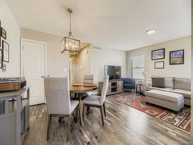 a living room with furniture a table and a flat screen tv