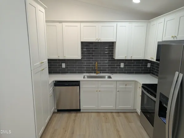 a kitchen with a sink stove and refrigerator