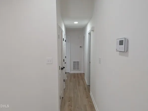 a view of a hallway with wooden floor