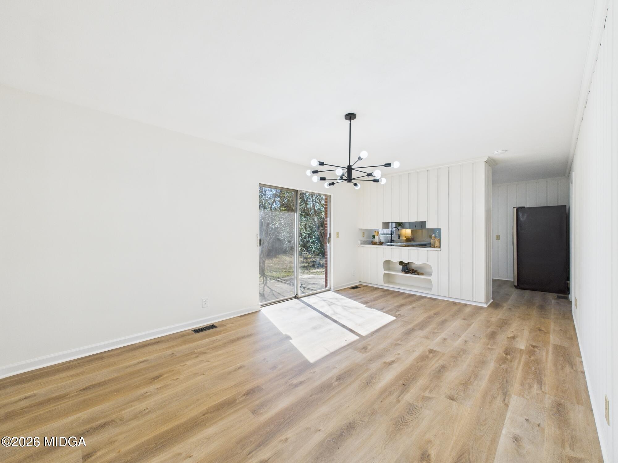 1432 Duncan Avenue Perry, GA 31069 - Photo 12 of 46 a view of a livingroom with a chandelier fan and wooden floor