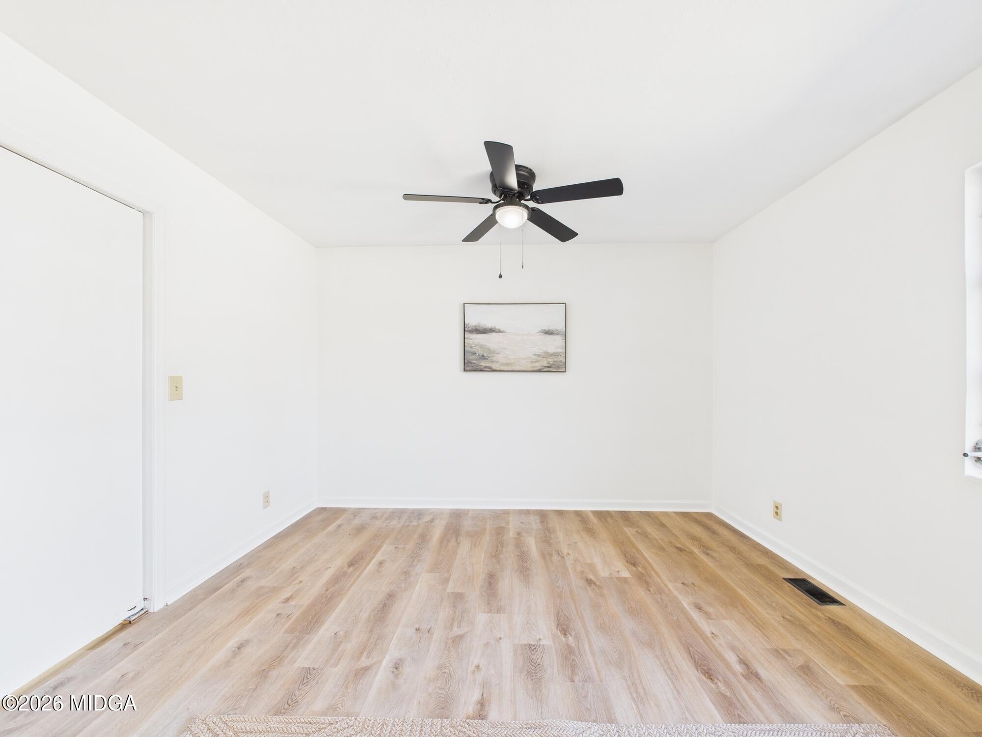 1432 Duncan Avenue Perry, GA 31069 - Photo 13 of 46 a view of a room with wooden floor and a ceiling fan