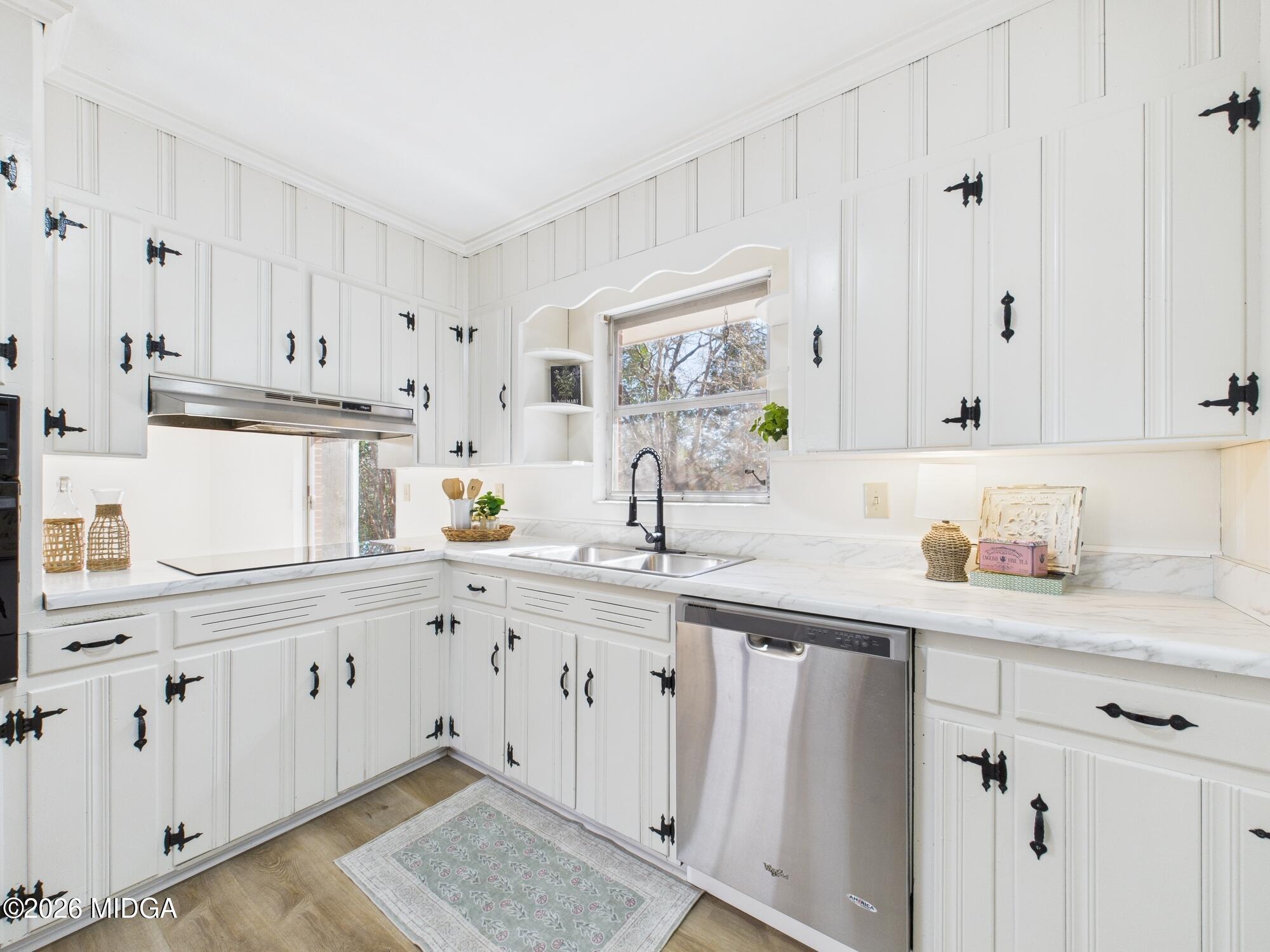 1432 Duncan Avenue Perry, GA 31069 - Photo 18 of 46 a kitchen with white cabinets and sink