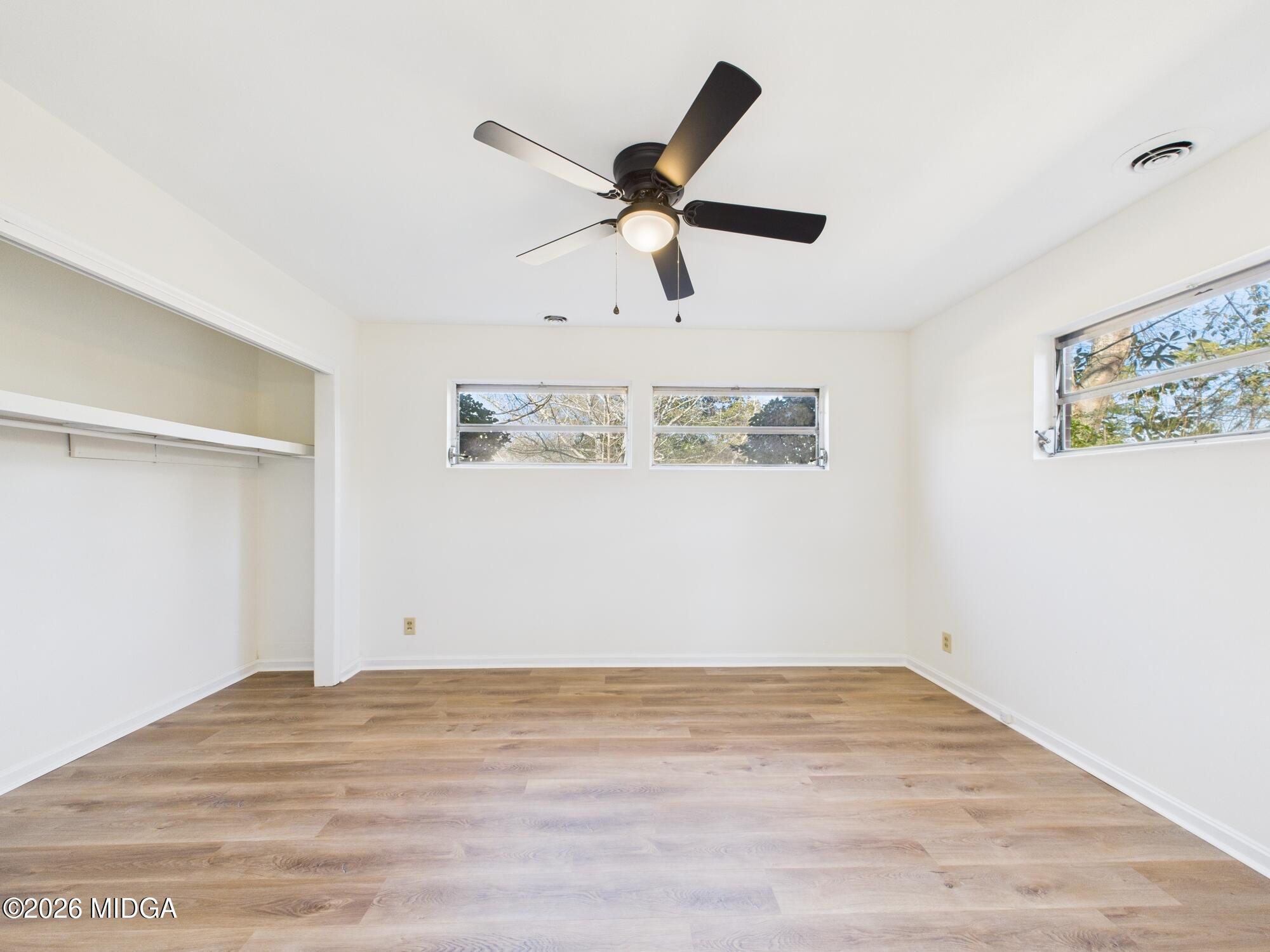 1432 Duncan Avenue Perry, GA 31069 - Photo 24 of 46 a view of room with wooden floor and ceiling fan