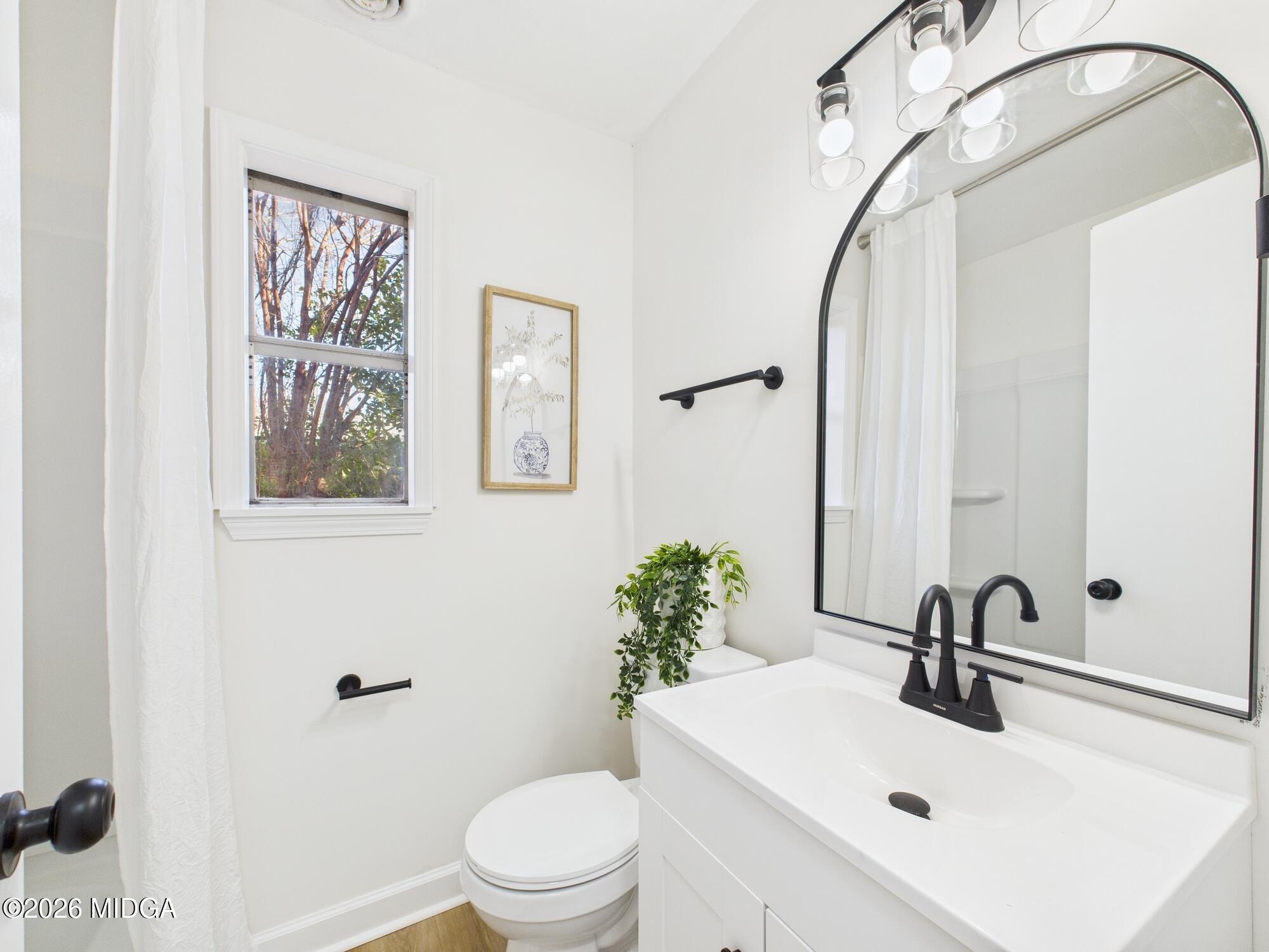 1432 Duncan Avenue Perry, GA 31069 - Photo 26 of 46 a bathroom with a sink mirror and toilet