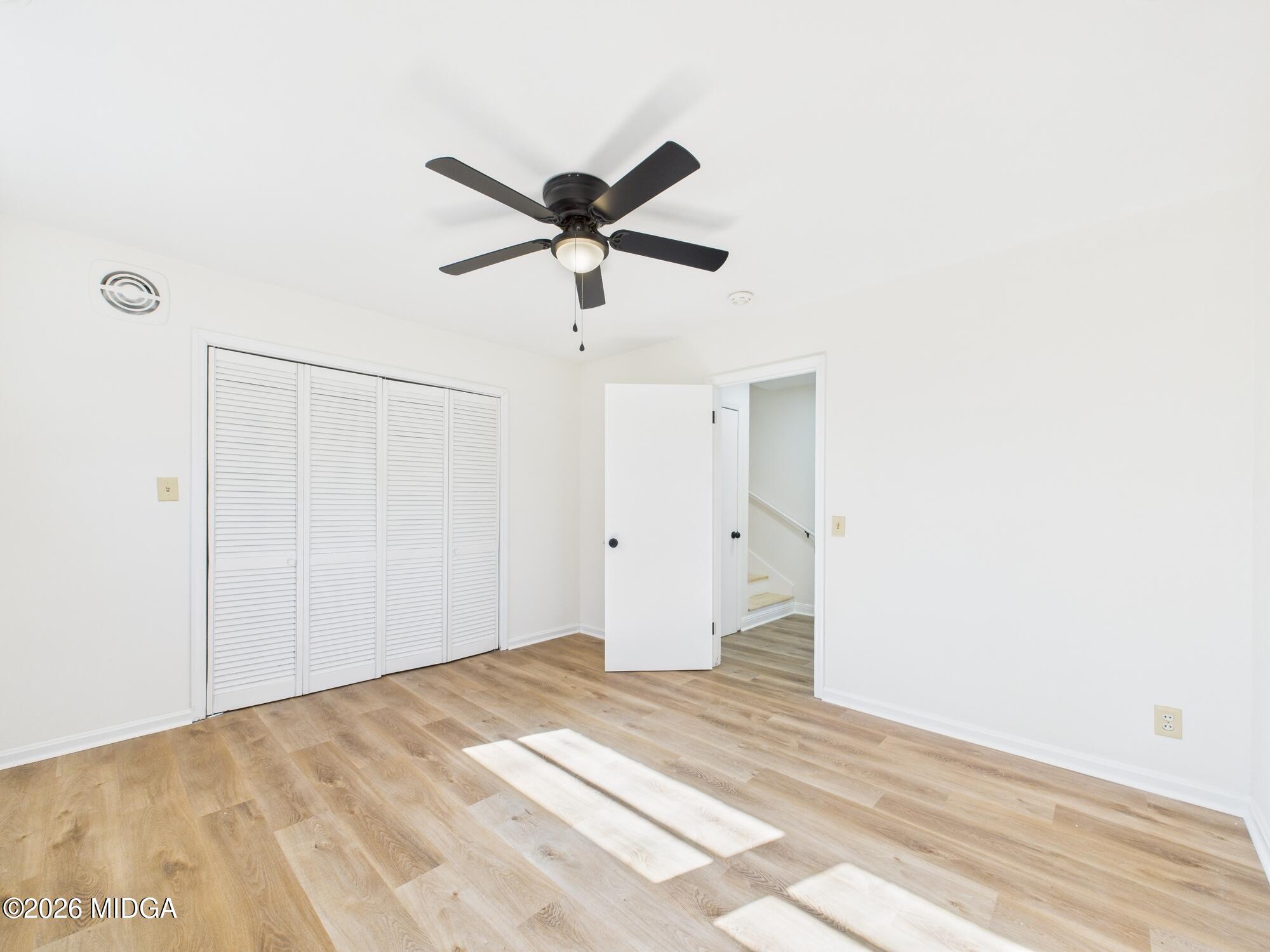 1432 Duncan Avenue Perry, GA 31069 - Photo 29 of 46 a view of a big room with wooden floor and a ceiling fan