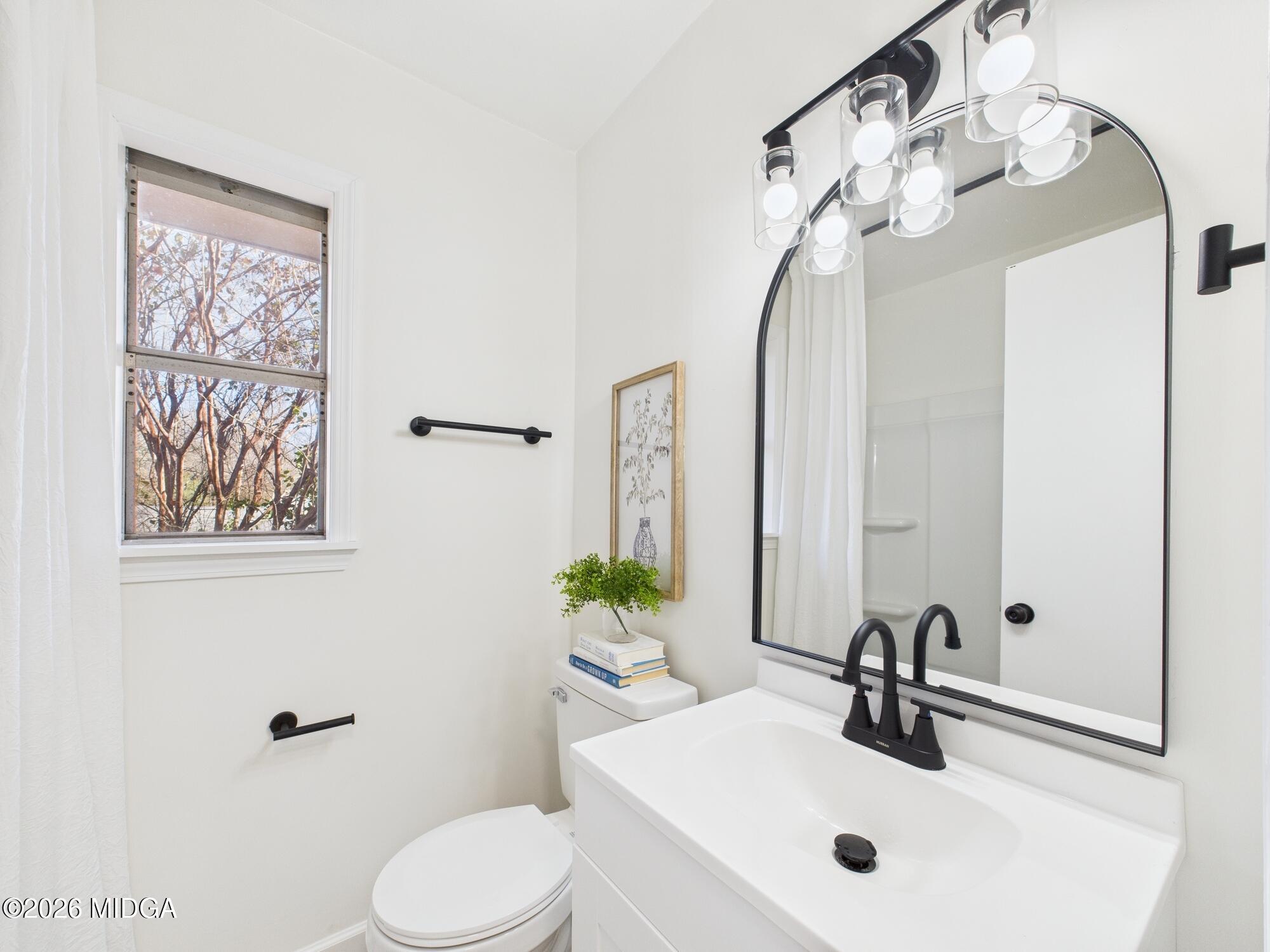 1432 Duncan Avenue Perry, GA 31069 - Photo 32 of 46 a bathroom with a sink a toilet and a mirror