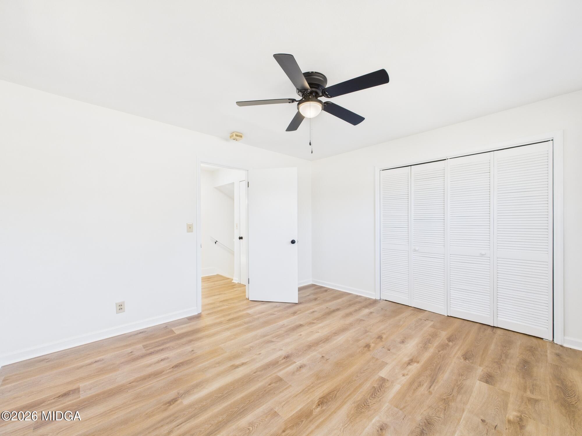 1432 Duncan Avenue Perry, GA 31069 - Photo 35 of 46 a view of a big room with wooden floor and a ceiling fan