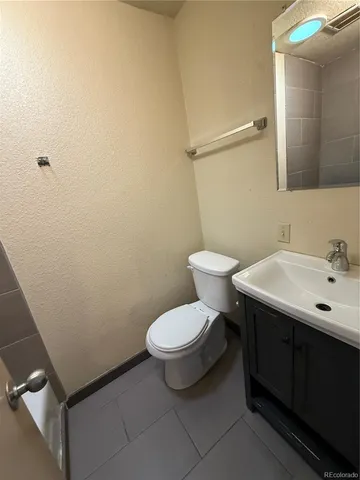 a white toilet sitting next to a bathroom sink