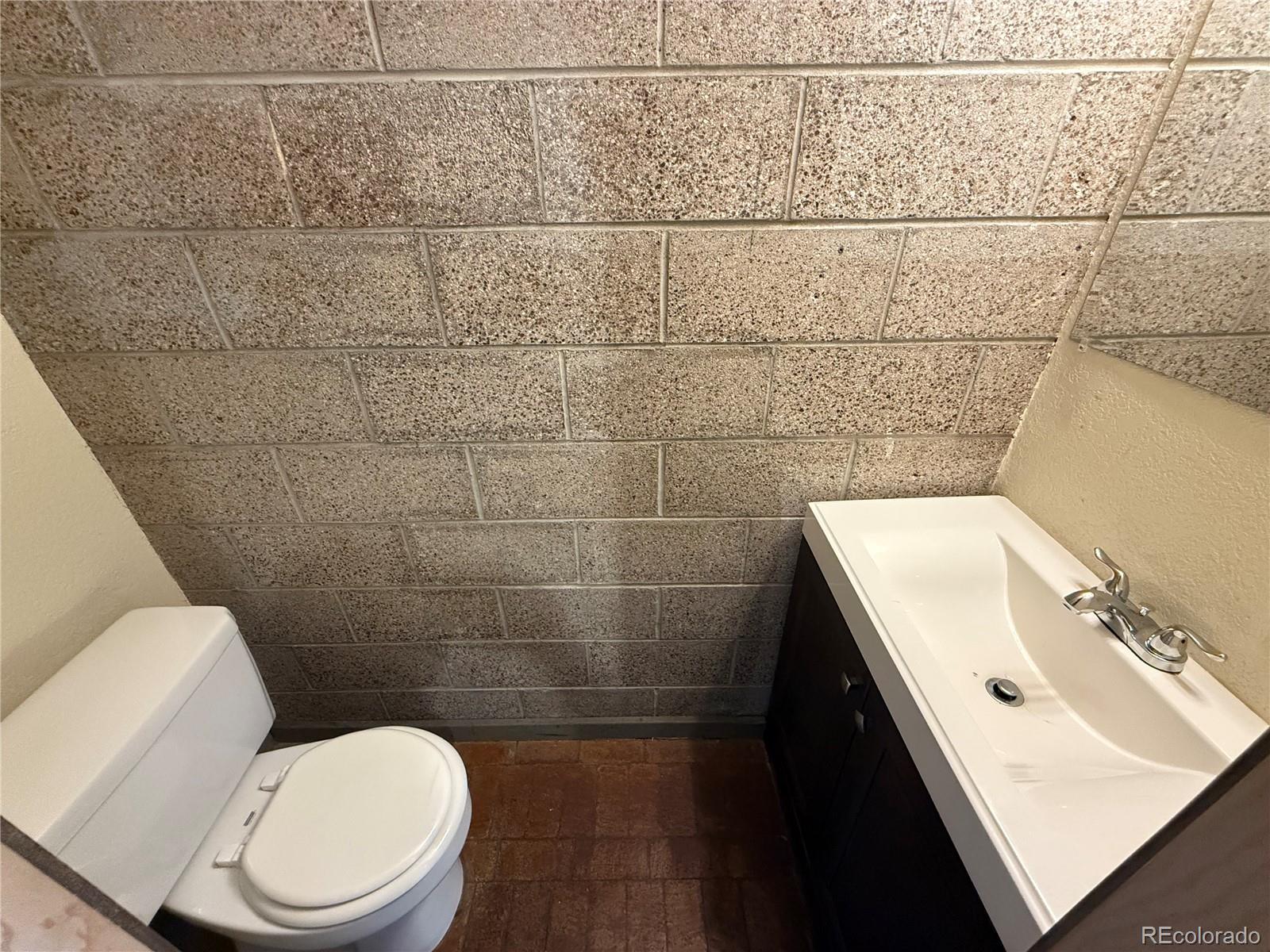 1131 21st Street Denver, CO 80205 - Photo 6 of 15 a bathroom with a sink and a toilet