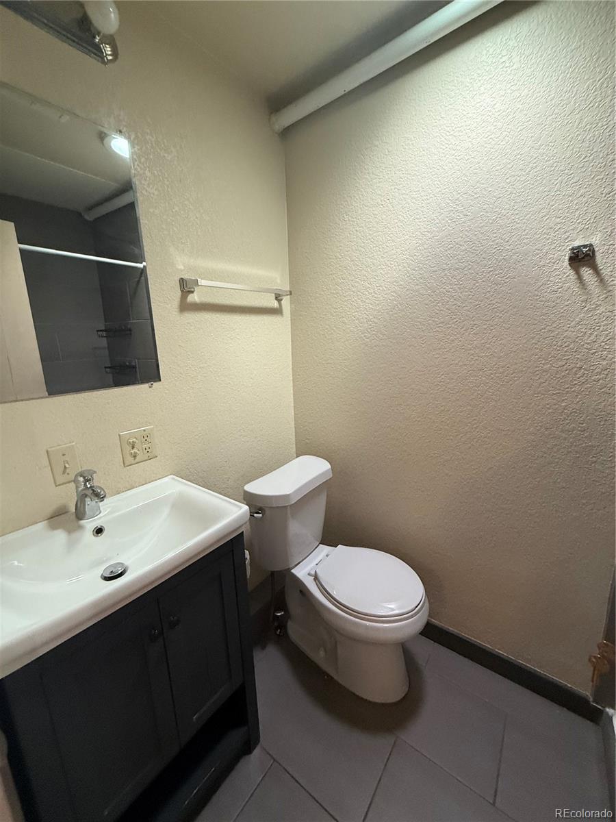 1131 21st Street Denver, CO 80205 - Photo 10 of 15 a bathroom with a sink and a toilet