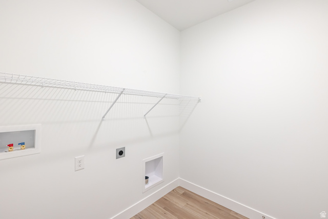 675 West 4500th South, Unit P204 Mapleton, UT 84664 - Photo 4 of 16 Dedicated laundry space featuring a wire shelving unit, appliance hookups, and wood-finish flooring