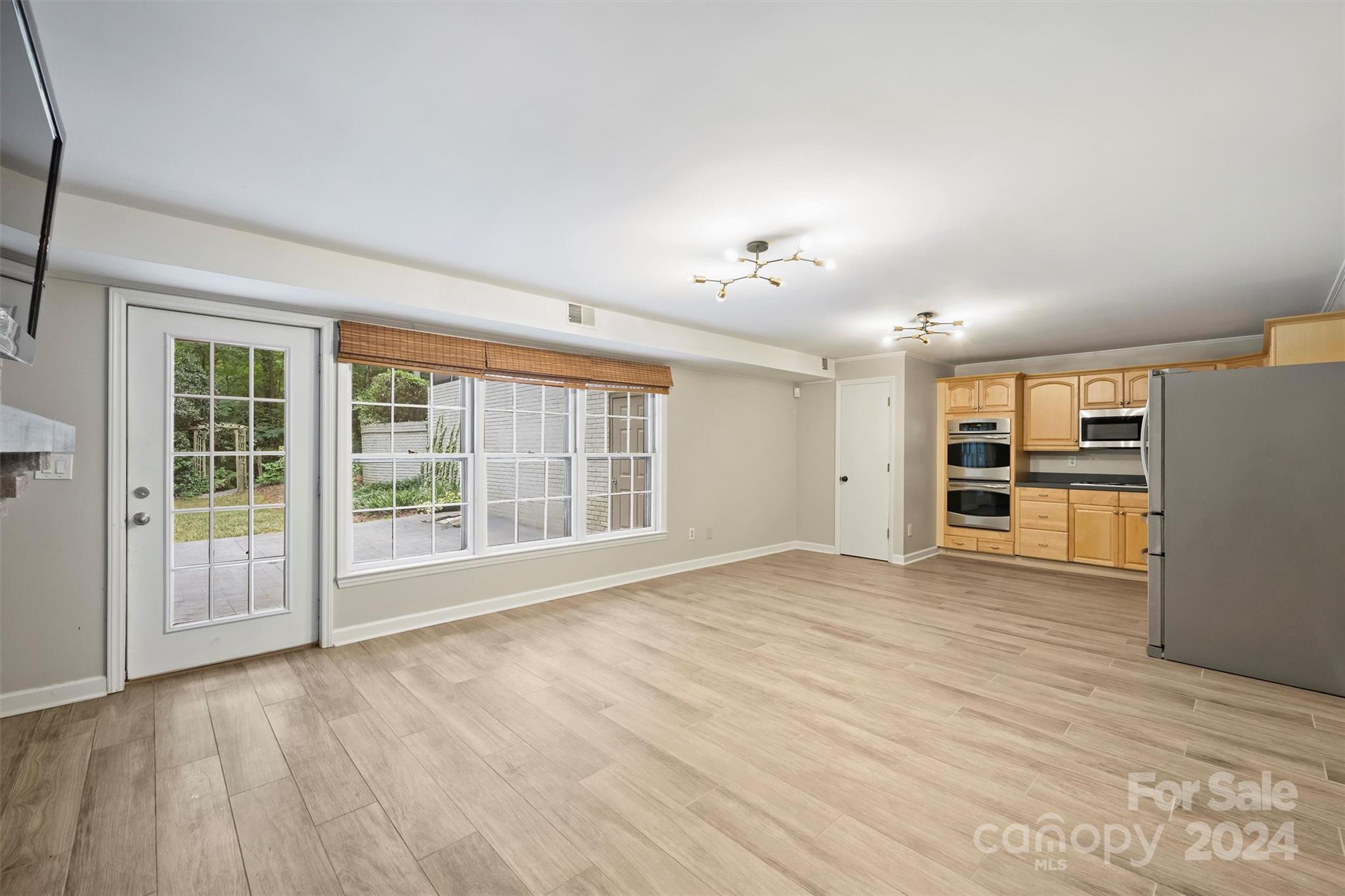 207 Crescent Drive Davidson, NC 28036 - Photo 30 of 43 a view of an empty room with a window and wooden floor