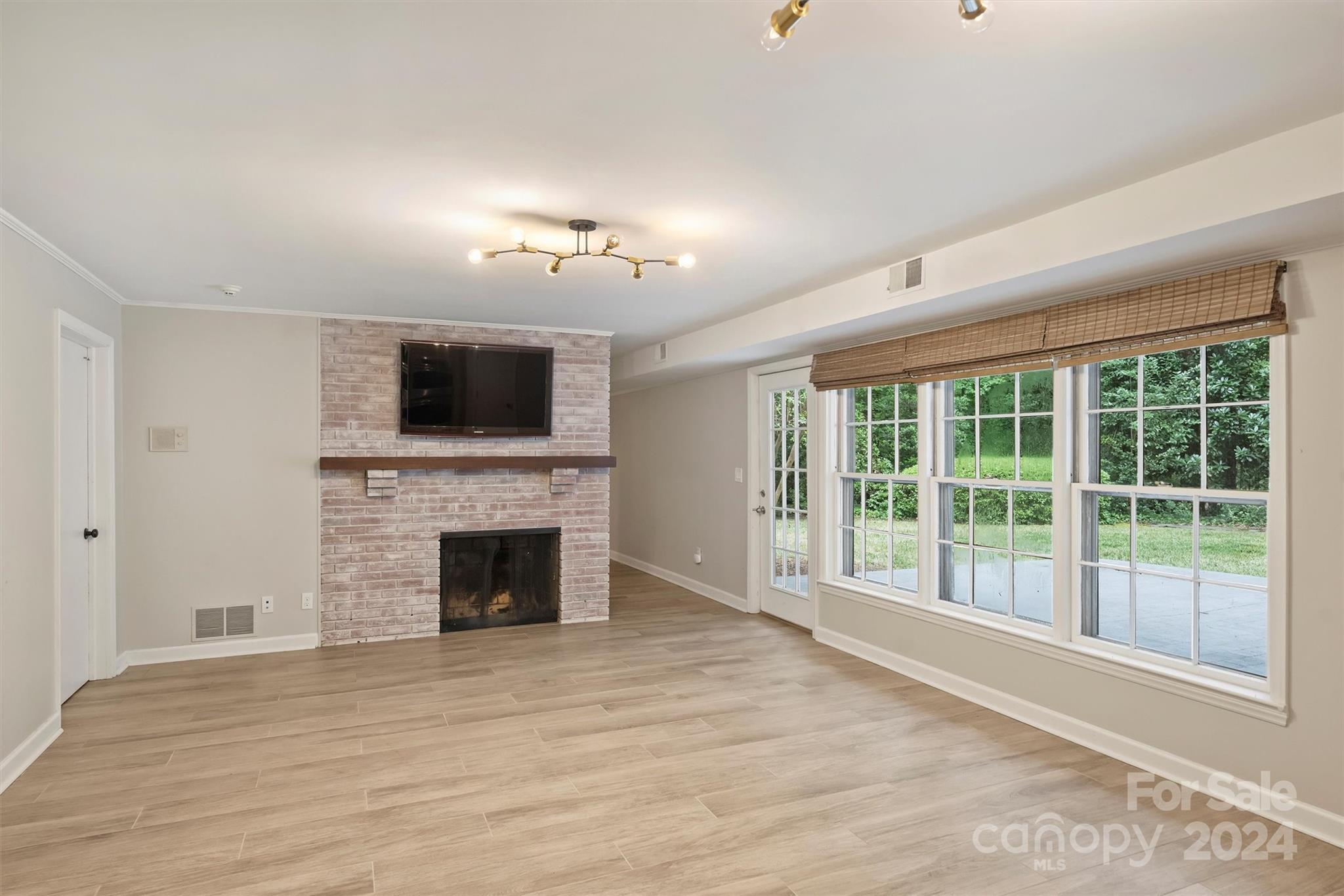 207 Crescent Drive Davidson, NC 28036 - Photo 32 of 43 a view of an empty room with a fireplace and a window