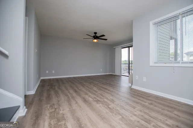wooden floor in an empty room with a window