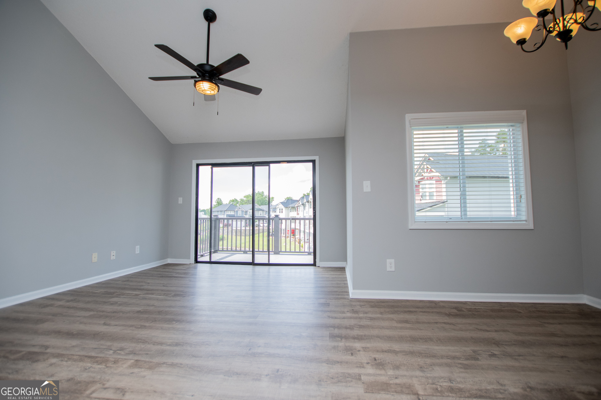 325 Berry Court Villa Rica, GA 30180 - Photo 14 of 43 a view of an empty room with wooden floor and a window