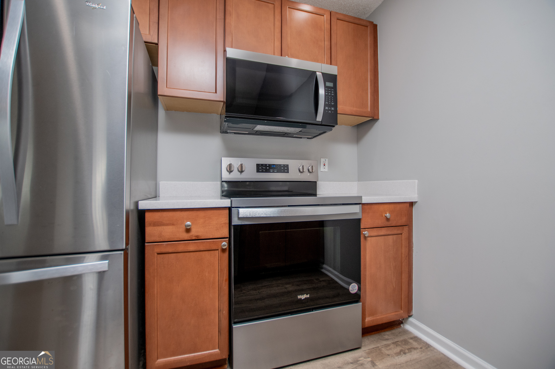325 Berry Court Villa Rica, GA 30180 - Photo 15 of 43 a utility room with stainless steel appliances wooden floor washer and dryer