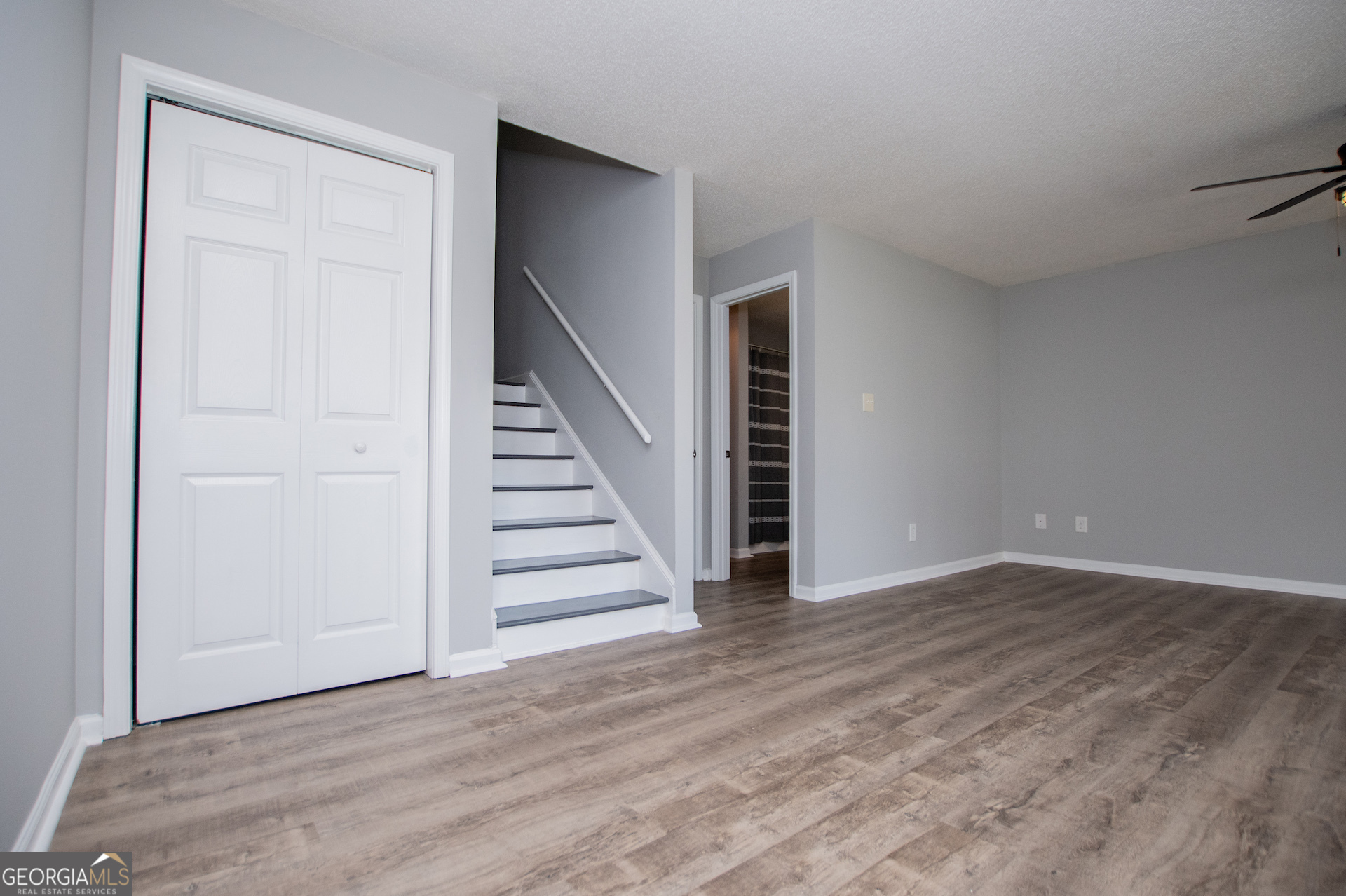 325 Berry Court Villa Rica, GA 30180 - Photo 18 of 43 wooden floor in an empty room with stairs