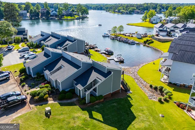 an aerial view of a swimming pool with outdoor seating