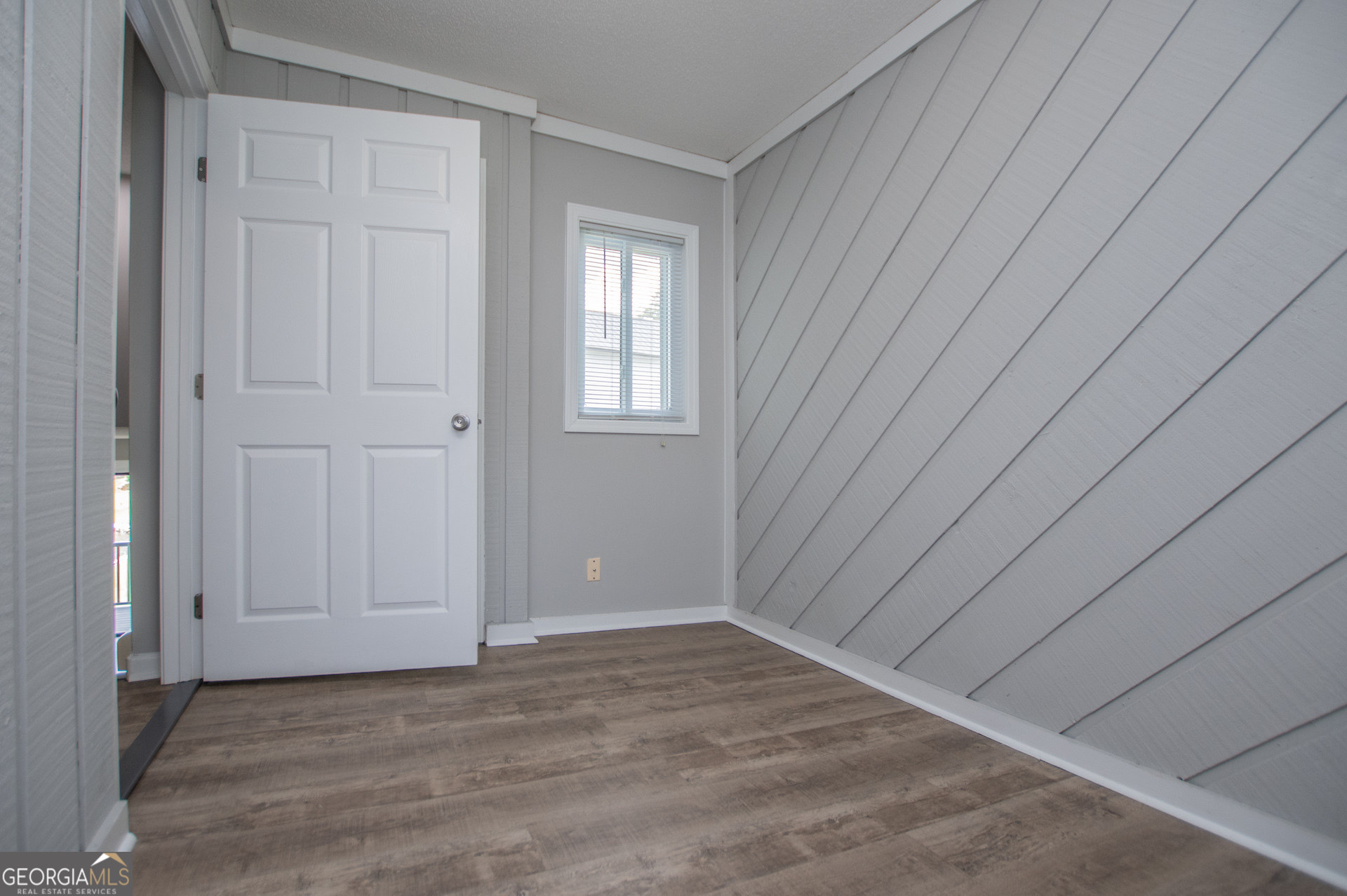 325 Berry Court Villa Rica, GA 30180 - Photo 6 of 43 a view of an empty room with window and wooden floor
