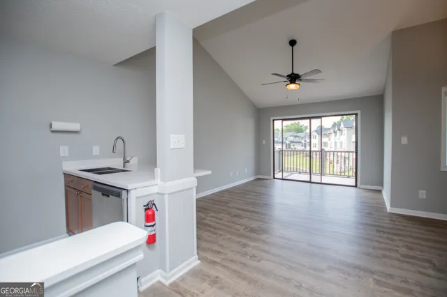 a storage room with wooden floor and ceiling fan