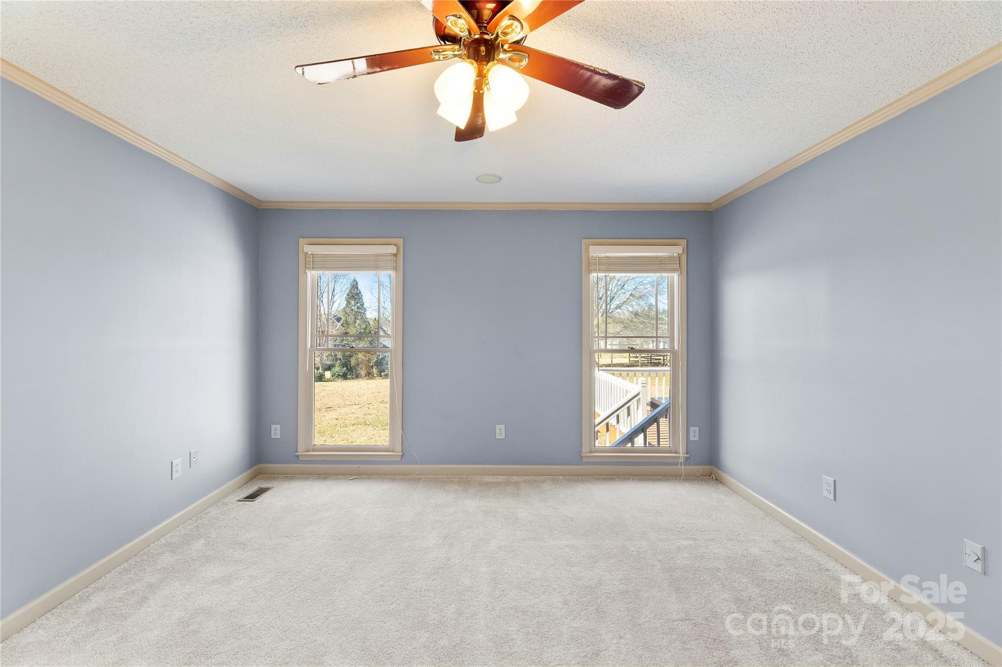 1351 Hardin Road Dallas, NC 28034 - Photo 18 of 39 an empty room with windows and chandelier fan
