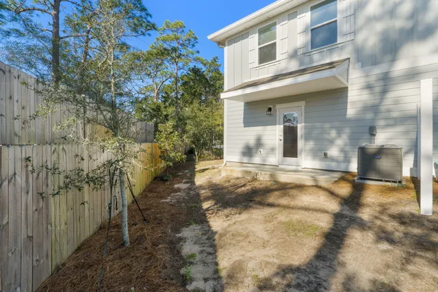 a view of a brick house with a yard