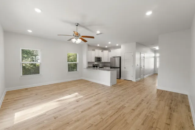 a view of a kitchen with a sink and a refrigerator