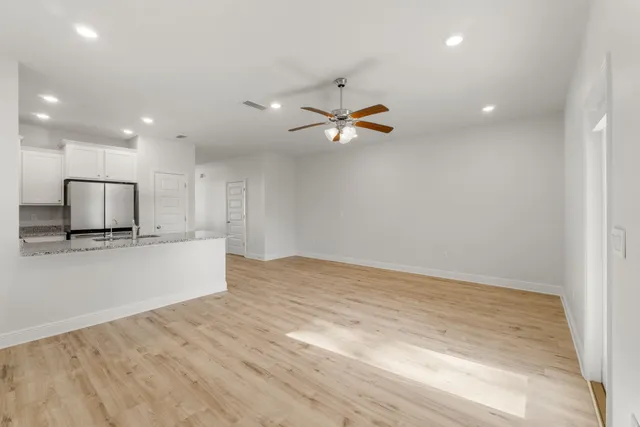 a view of a kitchen with a sink and a ceiling fan