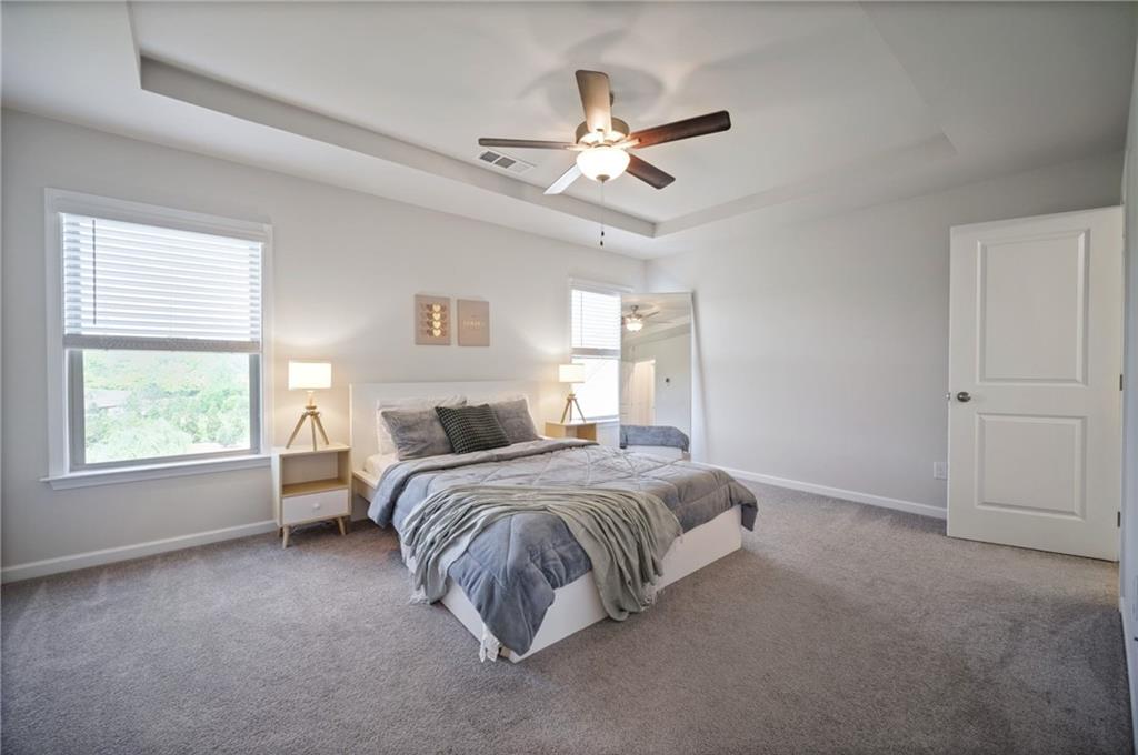 1595 Ridgebrook Downs Mableton, GA 30126 - Photo 17 of 39 a spacious bedroom with a bed and window