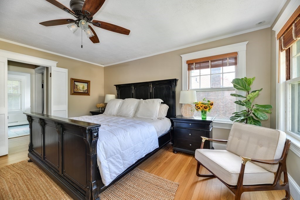 104 Manet Road Newton, MA 02467 - Photo 13 of 24 a bedroom with a bed and wooden floor