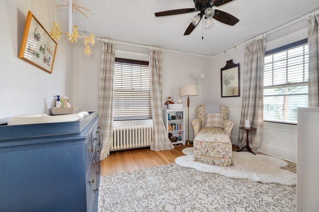 104 Manet Road Newton, MA 02467 - Photo 16 of 24 a bedroom with a bed and wooden floor