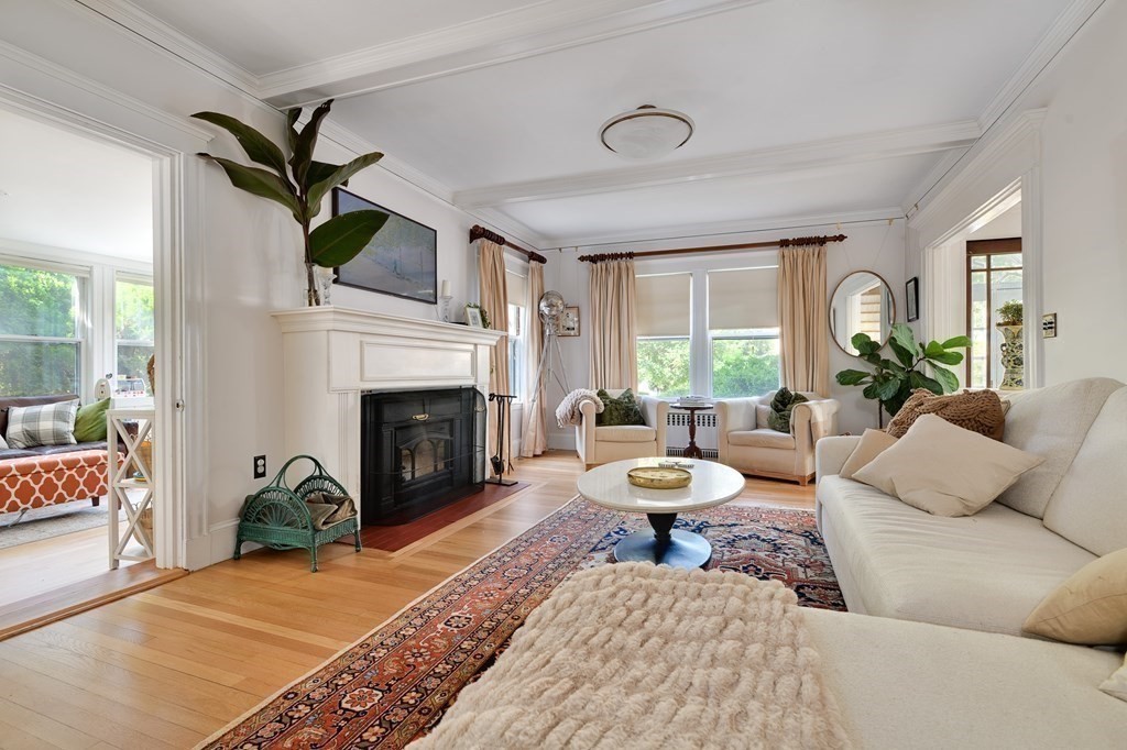 104 Manet Road Newton, MA 02467 - Photo 2 of 24 a living room with furniture a fireplace and a table