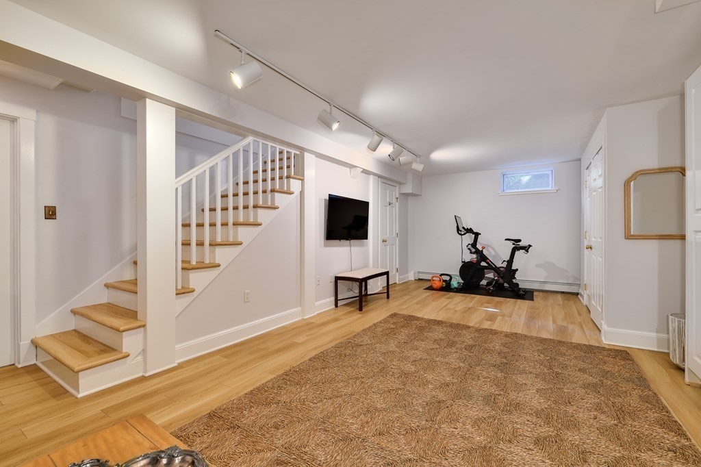 104 Manet Road Newton, MA 02467 - Photo 21 of 24 a view of a livingroom with workspace and a flat screen tv