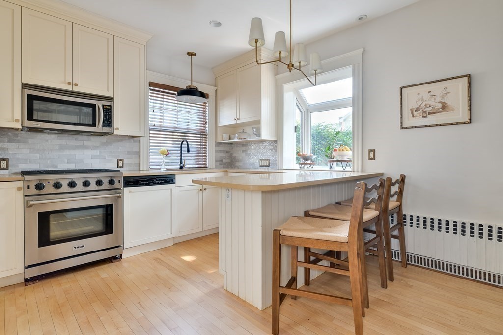 104 Manet Road Newton, MA 02467 - Photo 7 of 24 a kitchen with stainless steel appliances granite countertop a stove a sink and a microwave