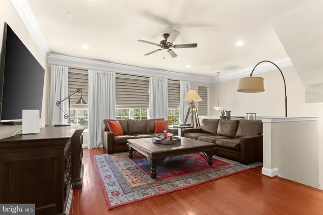 a living room with furniture a large window and a flat screen tv