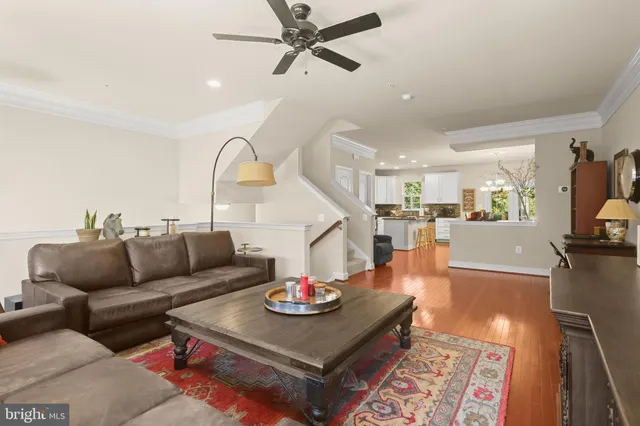 a living room with furniture and kitchen view