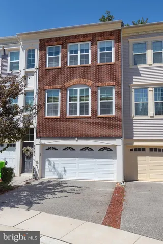 a front view of a building with a yard and a garage