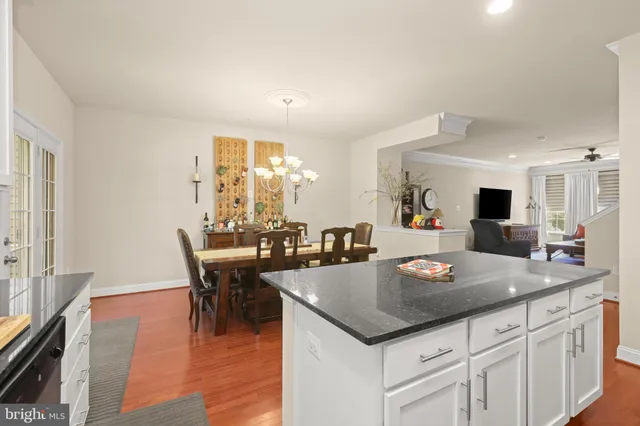 a view of kitchen island dining table and wooden floor