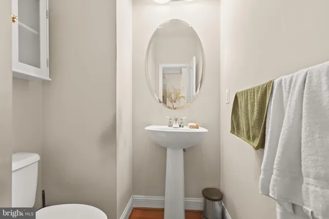 a bathroom with a sink toilet and a mirror