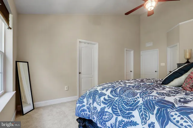 a bedroom with a bed and a mirror