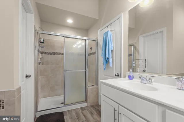 a bathroom with a shower sink and mirror